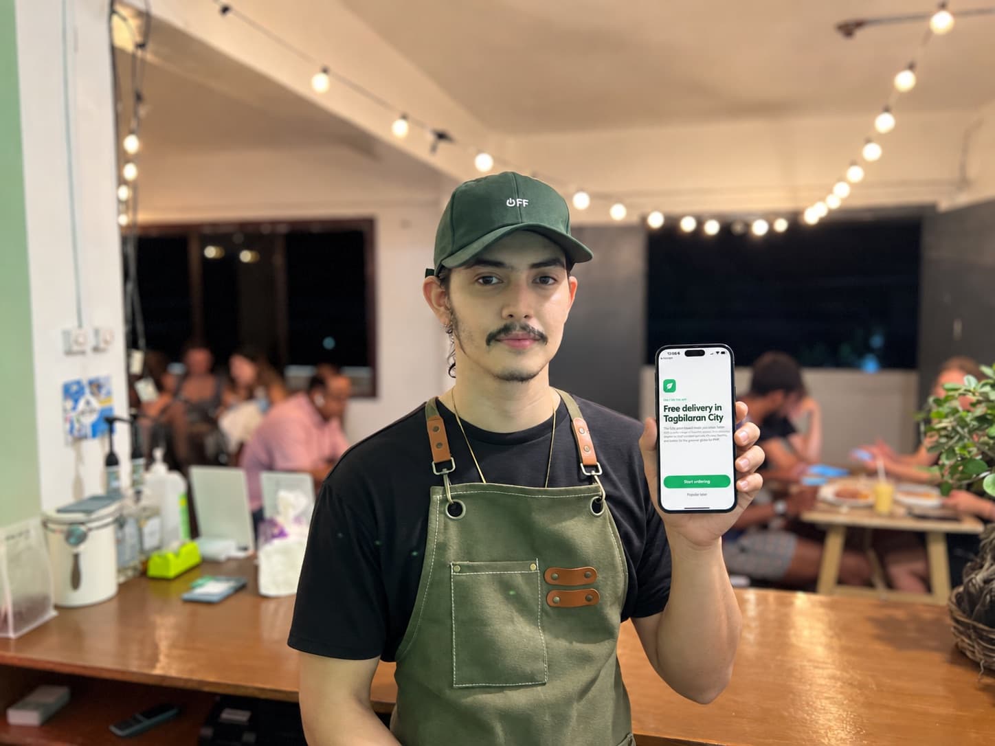Veganize staff holding up the Veganize app